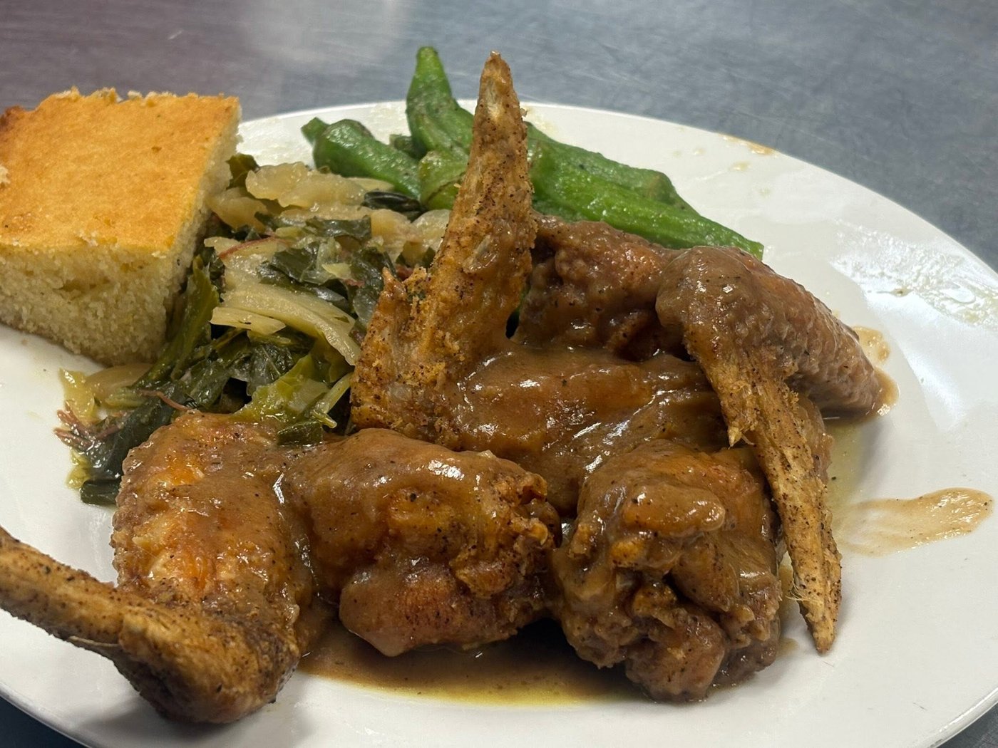 Smothered chicken with greens, cornbread and okra